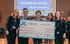 Georgetown winners of VHacks holding oversized check