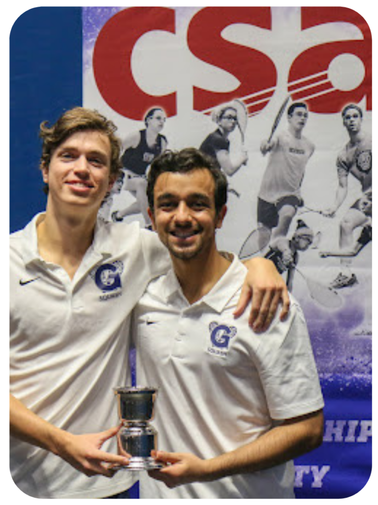 Two men in squash uniforms holding a trophy