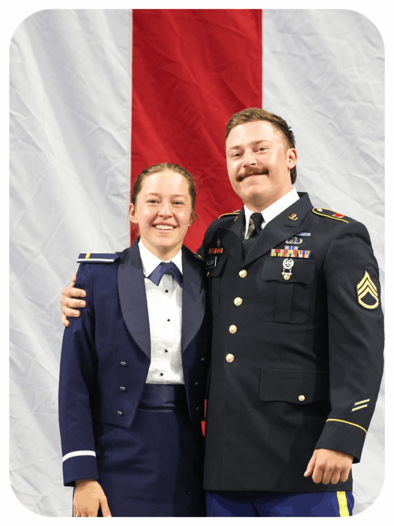 Erin B. and officer standing in front of a red and white striped background in uniform.