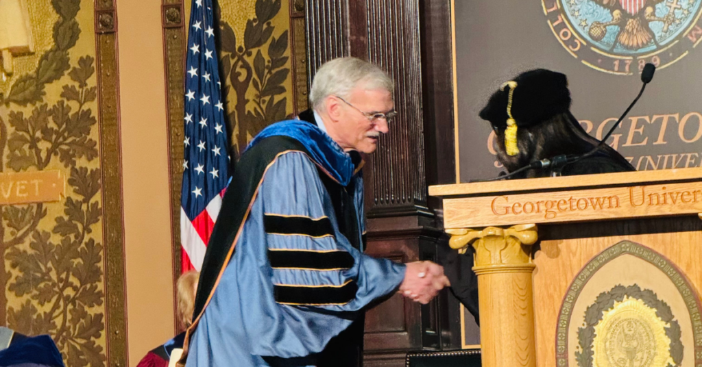 Provost Robert Groves shakes Dr. Gamage's hand during the ceremony