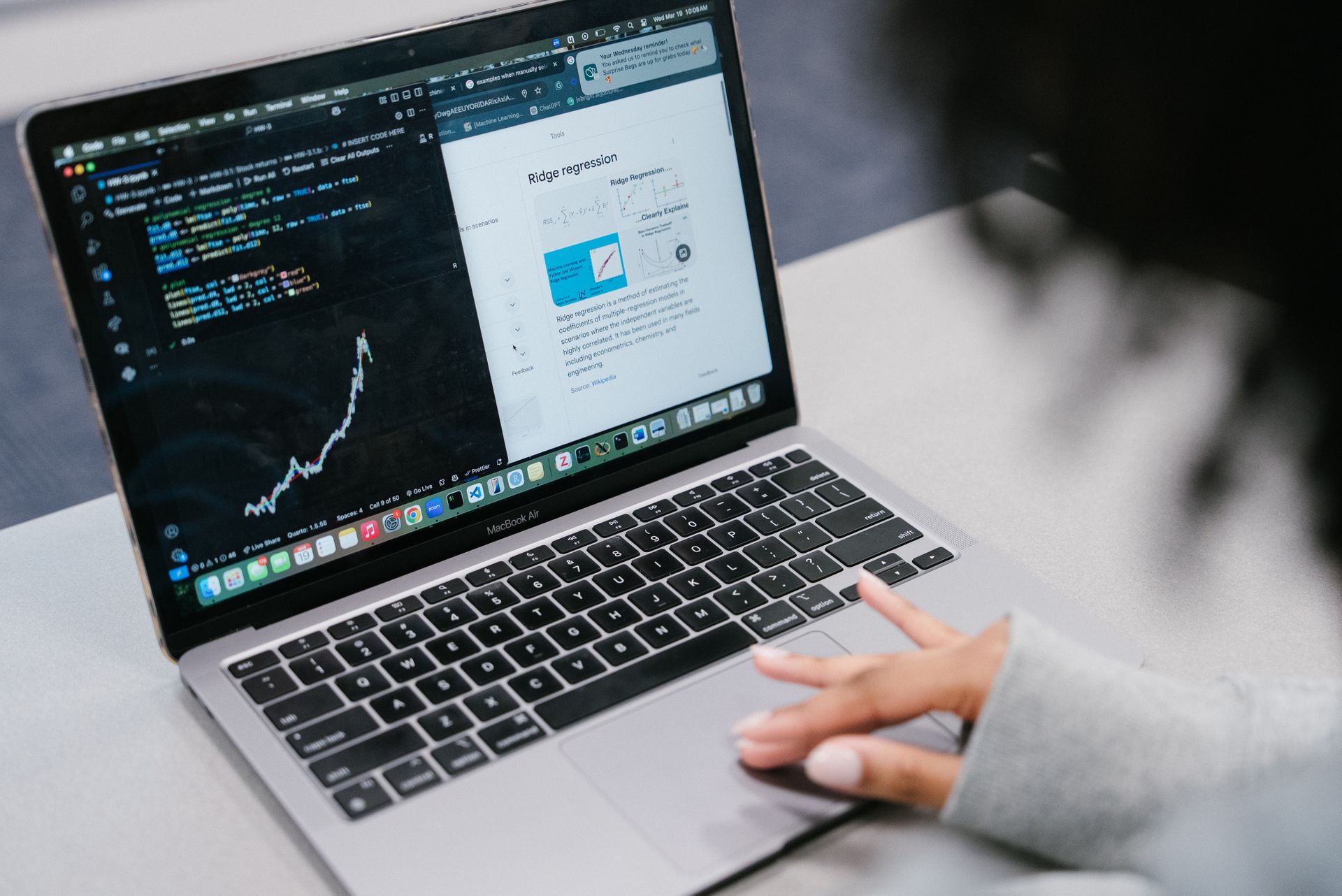 A laptop displays data files and a preview of a webpage.