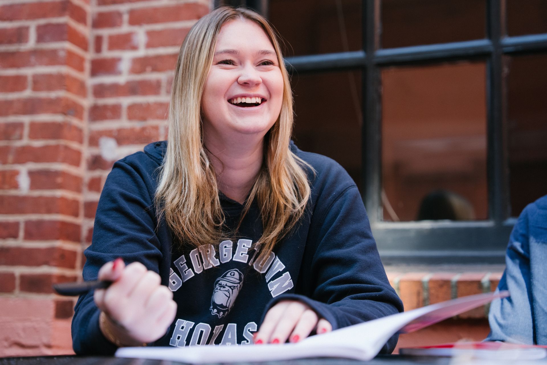 A student laughs while studying.