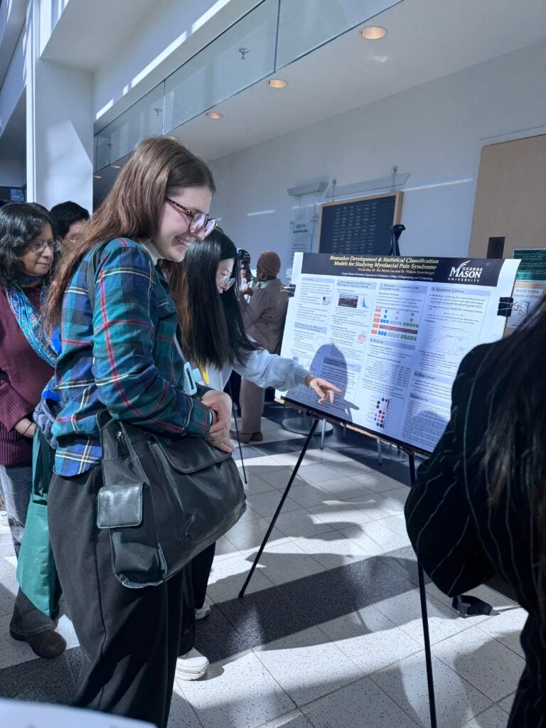 Poster session attendees view student posters