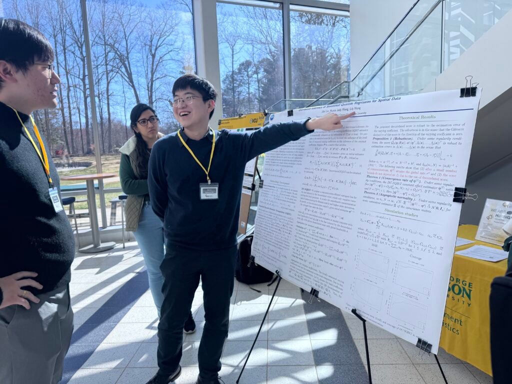 Student presenting his poster