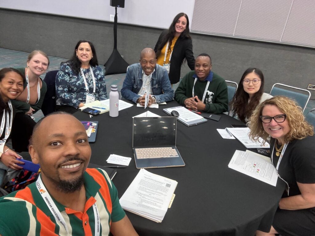 Yuxi with other AERA attendees at a round table