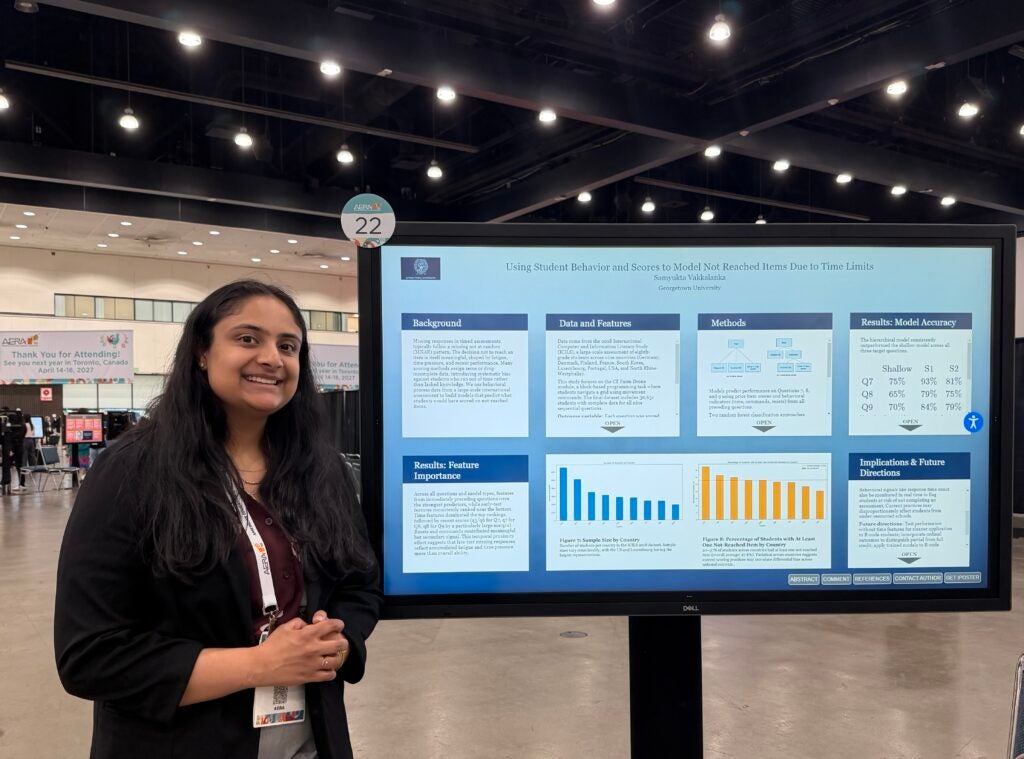 Samyu standing in front of her digital poster